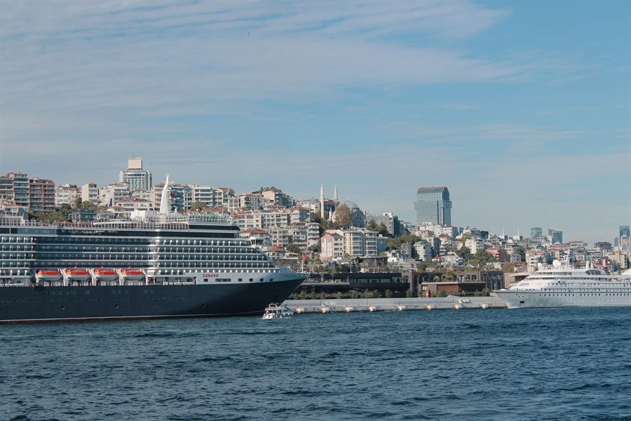 Cruise ship docked in a busy city harbor