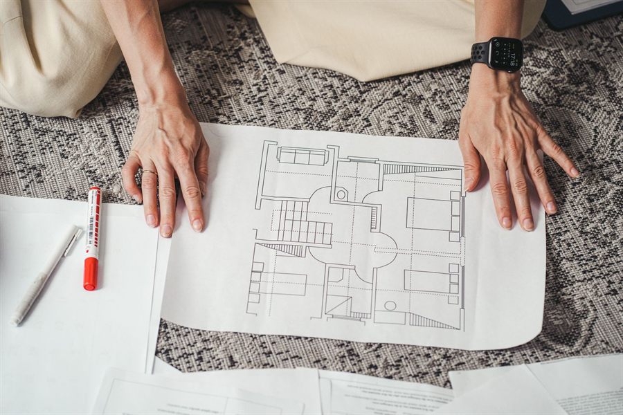 Hands holding a floor plan drawing