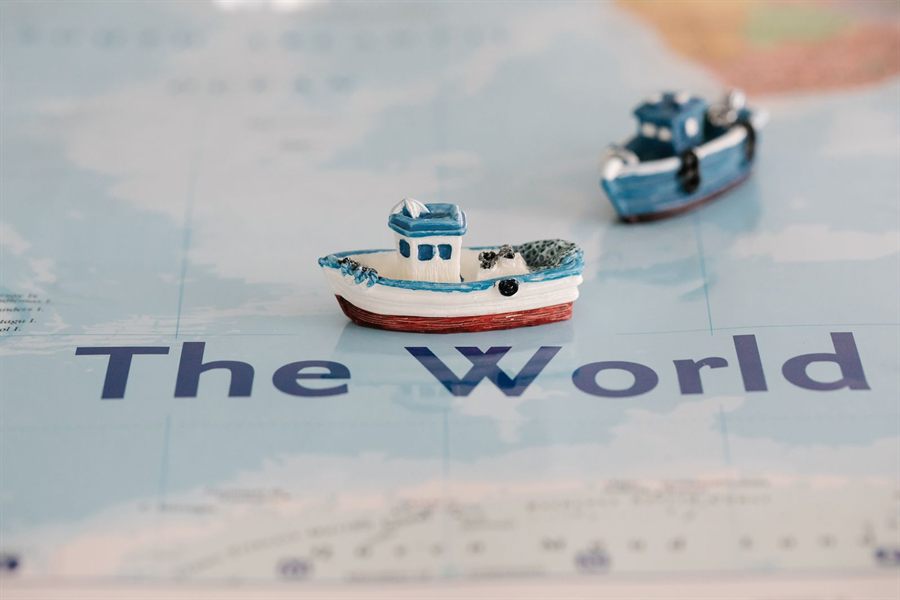 Toy boats sailing across a map of the world